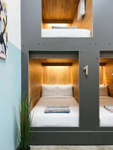 two images of a bed in a room at UrbanKey Pods - Vienna Neubau in Vienna