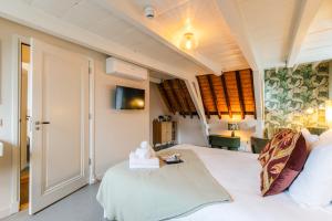 a bedroom with a large white bed in a room at Brass Hotel in Utrecht