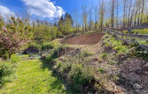 a dirt hill with a wooden fence and trees at La Terrasse in La Pervenche +8 photos