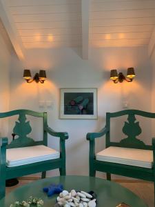 two green chairs and a table in a room at Anassa Boutique Beach House in Sami