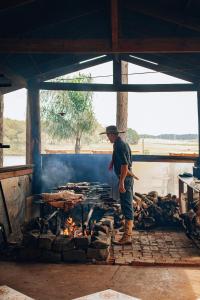 a man standing in front of a fire at Tedesco Eco Park in São Francisco de Paula