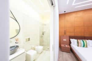a bathroom with a sink and a toilet and a shower at Giulio Cesare Luxury Rooms in Rome +107 photos