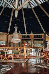 a large room with a chandelier and tables and chairs at Tedesco Eco Park in São Francisco de Paula