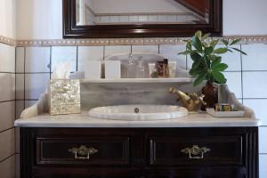 a bathroom counter with a sink and a mirror at Anassa Boutique Beach House in Sami +37 photos