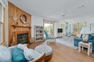 a living room with a couch and a fireplace at 3660 - Duckingham in Duck