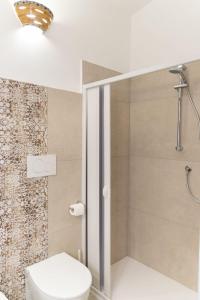 a bathroom with a toilet and a shower at B&B Golgo in Baunei