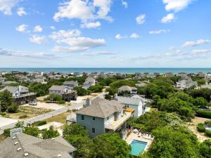 an aerial view of a neighborhood with houses and the ocean at 3945 - Sea Lodge II in Duck