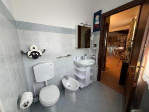 a bathroom with a toilet and a sink at La Corte di San Rocco in Murazzano +36 photos