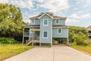 a blue house with a driveway in front of it at 3944 - Carolina Escape in Duck