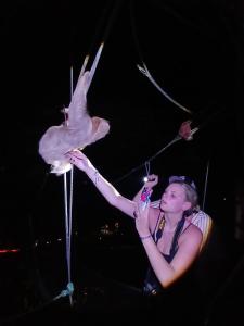 a woman holding a bird on a stick at Mountain Top Park Hotel in Manuel Antonio