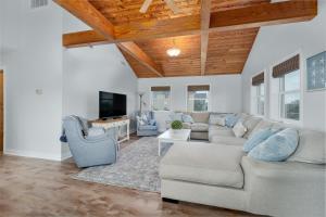 a living room with a couch and a tv at 3218 - Swab The Duck in Duck