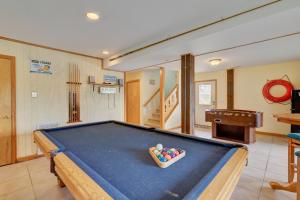a pool table in a living room with a bowl at 3218 - Swab The Duck in Duck