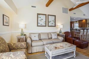 a living room with a couch and a coffee table at 3675 - Seaducktion in Duck