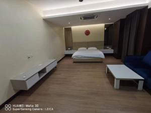 a hotel room with a bed and a couch at Sweetsweet homestay in Banting