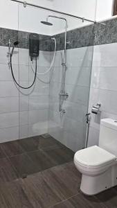 a bathroom with a shower with a toilet and a glass shower at Ophelia in Diyatalawa +13 photos