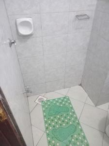 a shower with a green mat on the floor at Cavendish Square Studio Unit, Syokimau in Syokimau +5 photos