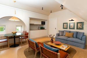 a living room with a couch and a table at Valverde Santar Hotel & SPA - Relais & Châteaux in Santar