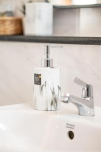 a soap dispenser sitting on top of a sink at Mango Villa แมงโก้ วิลล่า in Sa Kaeo +222 photos