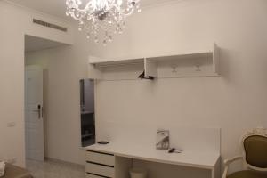 a kitchen with a white counter and a chandelier at Hotel Imperiale in Terzigno