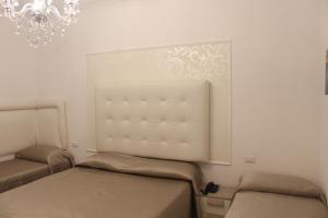 a bedroom with two beds and a chandelier at Hotel Imperiale in Terzigno +70 photos