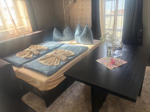 a table with two pillows on top of it at Ferienwohnung Müritz-Blick in Waren