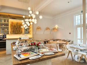 a restaurant with a table with food on it at Villa Astoria - Kühlungsborn in Kühlungsborn