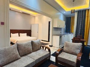 a living room with a couch and a bed at Pieme Hotel Residence in Migade