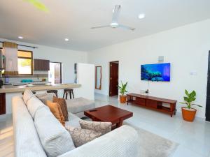 a living room with a couch and a table at Ntate Homes, Diani Near the Beach in Diani Beach