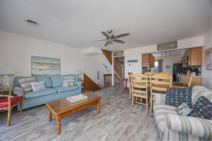 a living room with a couch and a table at 4208 - Naan Sands in Duck