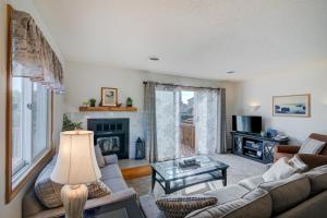 a living room with a couch and a fireplace at 4220 - Timeless in Duck +31 photos