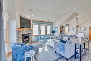 a living room with a couch and a fireplace at 4749 - Salty Dawgs in Kitty Hawk Beach