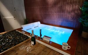 a swimming pool with a bottle of wine and a bottle of champagne at Mamaco Trani in Trani