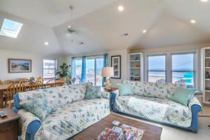 a living room with a couch and a table at 4759 - Sun Daze in Kitty Hawk Beach +46 photos