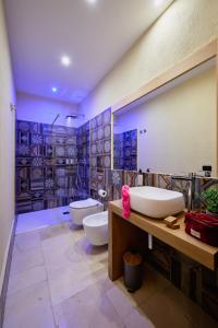 a bathroom with two sinks and two toilets at Mamaco Trani in Trani +28 photos