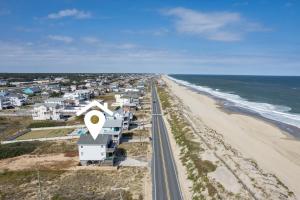 an aerial view of a beach with houses and a road at 4785 - Paradise Found in Kitty Hawk