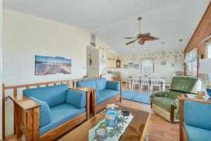a living room with blue couches and a dining room at 4785 - Paradise Found in Kitty Hawk +18 photos