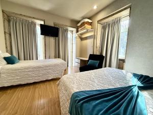 a hotel room with two beds and a chair at Residencial Portas do Sol in Valença +36 photos