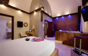 a bedroom with a large bed and a bathroom at Mamaco Trani in Trani