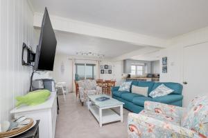 a living room with a blue couch and chairs at 5061 - Good Night Irene in Kill Devil Hills +23 photos
