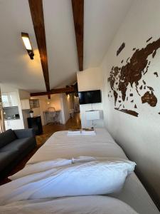a bedroom with two beds and a tv on the wall at Cosy attic flat Lausanne center in Lausanne