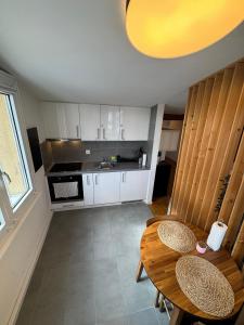 a kitchen with a wooden table and chairs and a dining room at Cosy attic flat Lausanne center in Lausanne