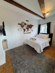 a bedroom with a bed with a map on the wall at Cosy attic flat Lausanne center in Lausanne +3 photos