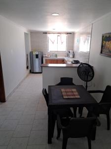 a kitchen and dining room with a table and chairs at Miss Leila in San Andrés +4 photos