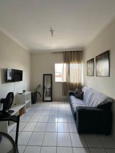 a living room with a couch and a television at next event patio for 06 people in Petrolina