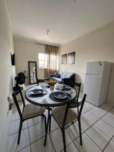 a living room with a table and chairs and a refrigerator at next event patio for 06 people in Petrolina