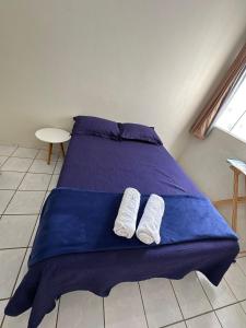 a blue bed with two white towels on it at next event patio for 06 people in Petrolina
