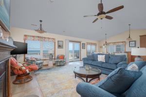 a living room with blue couches and a tv at 5437 - WeekAway in Nags Head