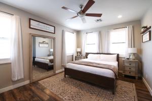 a bedroom with a bed and a large mirror at Central Luxury Mountain Oasis with TWO Pools and Jacuzzis in Phoenix +23 photos