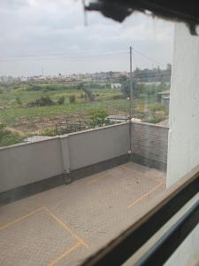 a balcony of a building with a view of a field at Cavendish Square Studio Unit, Syokimau in Syokimau