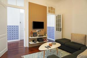 a living room with a couch and a table at Canto 30 e UM - HOST & CHILL in Ribeira Grande